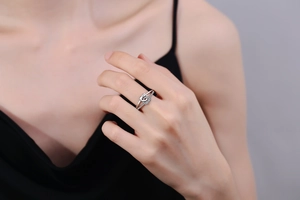 Detailed view of silver twist knot ring with micro-pave crystals on the index finger