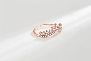 Macro view of rose gold crown ring featuring pavé setting stones and adjustable band