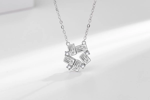 Close-up of geometric ferris wheel necklace with baguette zircon and polished finish