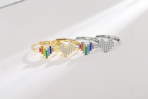 Close-up of heart-shaped rainbow zircon rings in gold and silver plating
