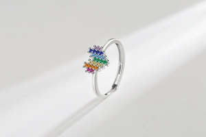Detail of rainbow cubic zirconia ring showing pixelated colorful gemstones on silver band