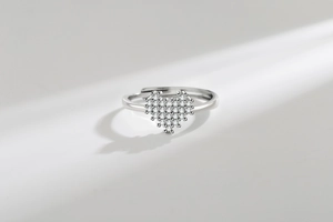 Detail of silver heart-shaped adjustable ring paved with sparkling cubic zirconia