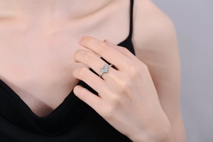 Macro shot of silver heart ring with pavé-set cubic zirconia on a model's finger