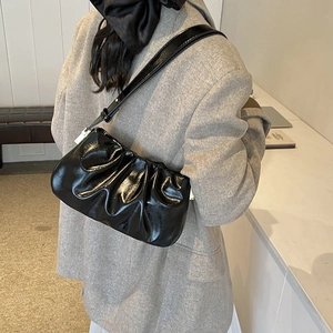 Chic black pleated cloud underarm bag in glossy finish with adjustable shoulder strap