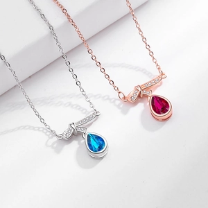 Elegant Heart of the Ocean teardrop necklace with crystal bow in blue and red gemstone