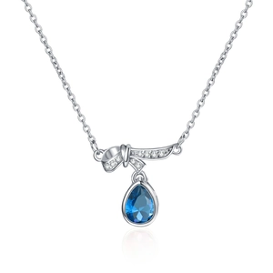 Silver bow necklace with a large teardrop blue crystal pendant on a white background