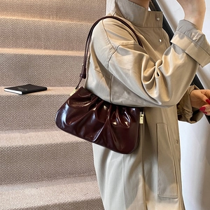 Retro burgundy cloud pleated underarm bag with glossy finish and gold zipper detail