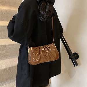 Brown pleated cloud shoulder bag with glossy PU leather and gold metal buckle accents