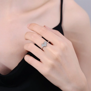 Silver heart ring with pavé rainbow zircon on finger, elegant minimalist design for women