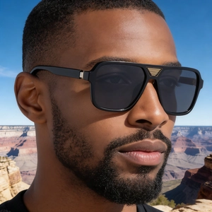 Close-up of black square polarized sunglasses with golden metal bridge detail on model