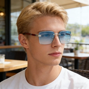 Close-up of square rimless sunglasses with blue gradient lenses and wood grain temples