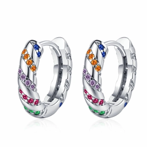 Silver twisted huggie earrings with colorful rainbow zircons on white background