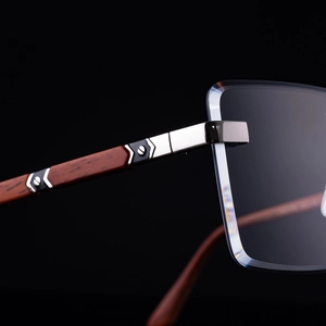 Detail of premium square rimless sunglasses with metal hinges and dark wood temples