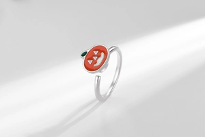 Detail of a spinning orange pumpkin ring with enamel finish for anxiety relief