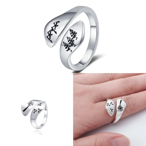 Macro detail of S925 sterling silver ring showing forest engraving and finger-worn look