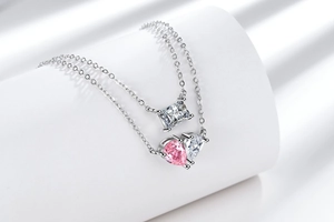 Macro detail of double-layer necklace with heart-shaped pink zircon and silver finish