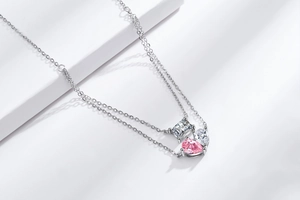 Detail of double-layered necklace with pink pear-shaped stone and square zircon
