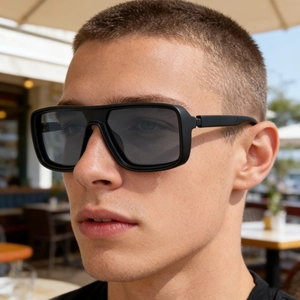 Close-up of matte black rectangular polarized sunglasses on male model in natural light