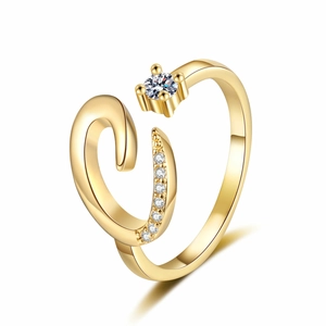 Detailed macro view of 18K gold letter ring with sparkling zircon stones and open band