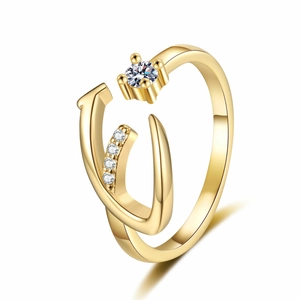 Close-up of gold-plated open ring featuring a sparkling zircon stone and pavé setting