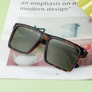 Chic tortoiseshell square frame sunglasses with dark lenses on a lifestyle magazine background