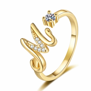 Macro detail of gold adjustable ring with crystal-encrusted letter M and large zircon stone
