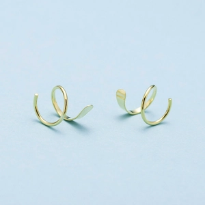 Detailed view of double layered gold spiral twist earrings with polished finish