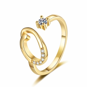 Detail of gold open ring featuring a sparkling round stone and spiral rhinestone accents