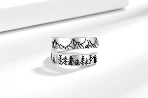 Detail of silver adjustable ring with oxidized mountain and forest relief carving
