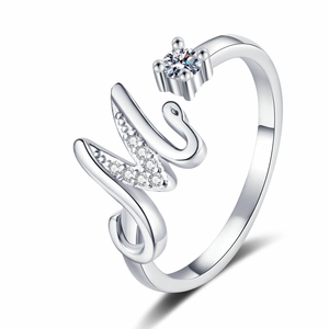 Detail of crystal paved letter M open ring with a round zircon in silver finish