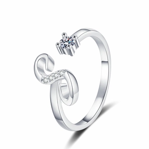 Macro shot of silver adjustable ring with four-prong setting and pavé side stones