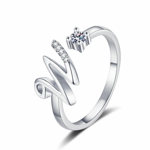 Close-up of silver adjustable ring featuring a pavé diamond M letter design