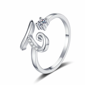 Detail of adjustable silver K-letter ring with sparkling round cubic zirconia and pavé accents