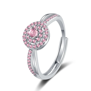 Macro detail of silver halo ring with pink round stone and adjustable open band