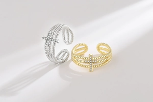 Detail of adjustable cross rings with triple beaded bands and micro-set zircon stones