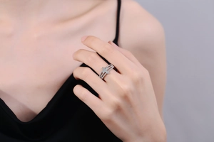 Detailed close-up of a silver cross ring featuring sparkling pavé zircon and cable band