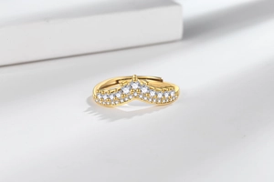 Macro detail of gold-plated V-shaped crown ring with pavé-set shimmering cubic zirconia