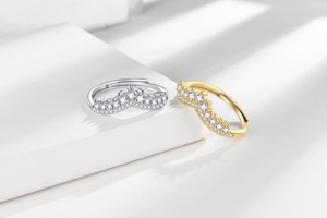 Detail of silver and gold crown-shaped adjustable rings with sparkling zircon inlay