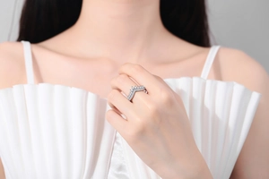 Detail of elegant V-shaped crown ring with cubic zirconia stones on model finger