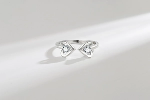 Macro detail of the double heart-shaped silver rings with sparkling cubic zirconia inlay