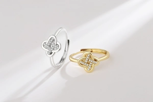 Detail of silver and gold clover rings with pave zircon crystals in striped shadow light