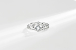 Detail of crown ring with sparkling zircon stones and adjustable open silver band