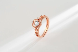Detail shot of rose gold crown ring with clear central crystal and adjustable band
