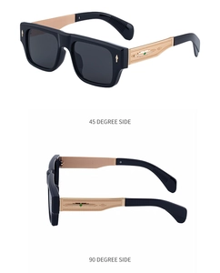Detail view of square sunglasses with gold textured temples and green emblem detail