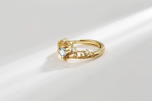 Close-up of gold S925 crown ring with sparkling round diamond and filigree detail
