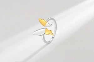 Macro detail of adjustable butterfly ring with two-tone gold and silver finish