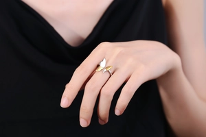 Detail of elegant two-tone butterfly open ring featuring gold and silver metal wings