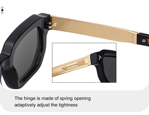 Détail des charnières à ressort et des branches dorées gravées sur les lunettes noires
