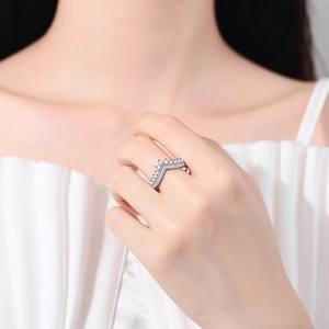 Elegant V-shaped zircon crown ring in polished silver finish worn by a model