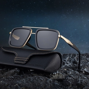 Retro double-bridge polarized sunglasses with gold-black frame on dark stone background